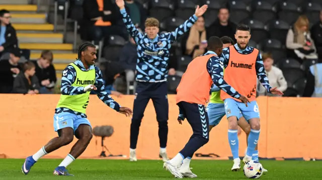 Coventry players warm up at Hull's MKM Stadium