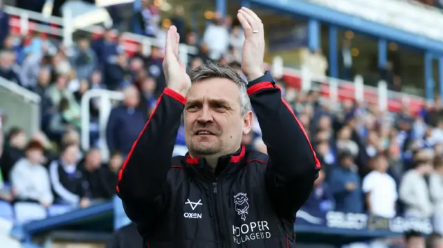 Lincoln boss Michael Skubala claps his hands in celebration at Reading