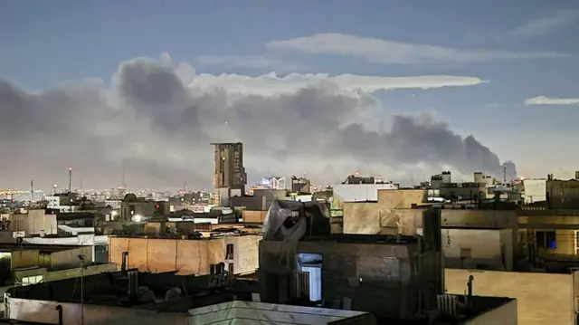 Smoke rises from residential areas in eastern and western parts of Tehran following airstrikes carried out by the United States and Israel in Tehran, Iran, on 6 April.