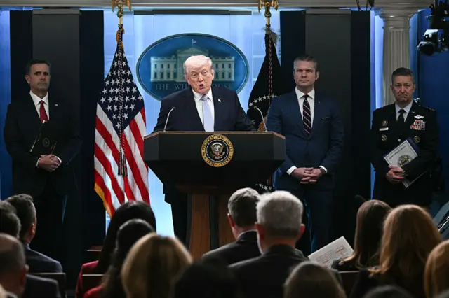 US President Donald Trump (centre at the podium), alongside CIA Director John Ratcliffe (behind him on the left), US Secretary of Defense Pete Hegseth (second right) and Chairman of the Joint Chiefs of Staff General Dan Caine (right)