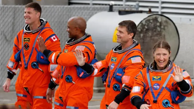 The crew of the Artemis II launch mission to fly by the moon, NASA astronauts Reid Wiseman, Victor Glover and Christina Koch and CSA (Canadian Space Agency) astronaut Jeremy Hansen greet people before boarding the astronaut van for their drive to launch pad 39B at the Kennedy Space Center in Cape Canaveral, Florida, U.S. April 1, 2026