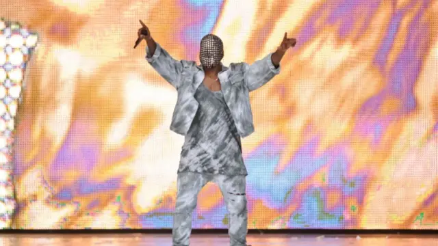 Kanye West in a chain metal mask, dressed all in grey at Wireless Festival 2014