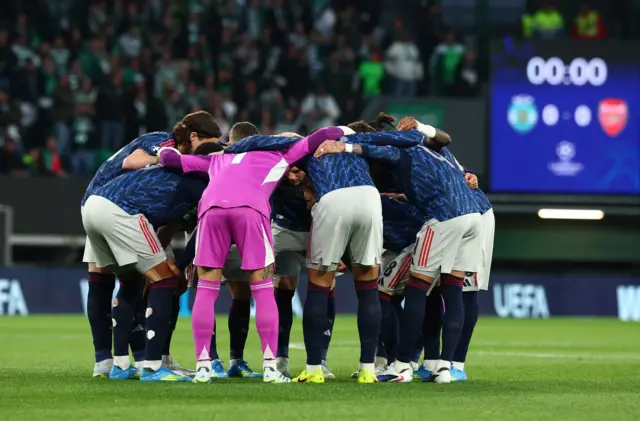 Arsenal players huddle before the match