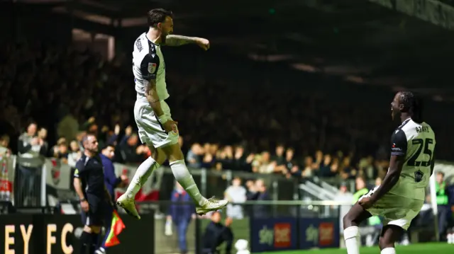 Kyle Cameron of Bromley jumps in the air as he celebrates after scoring a goal