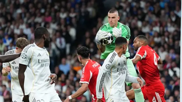 Andrii Lunin saves a shot