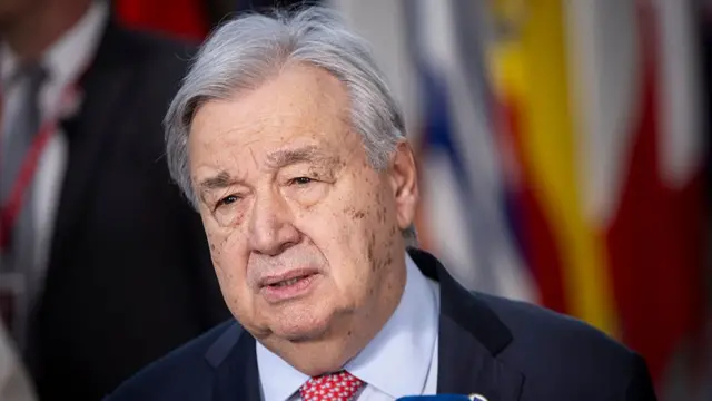 Guterres speaks into a mic during a conference