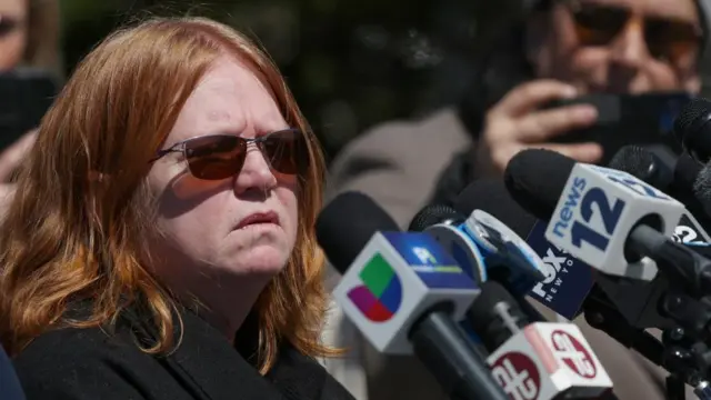 Close up photo of Asa Ellerup, estranged wife of accused Gilgo Beach serial killer Rex Heuermann, as she speaks in front of a bank of microphones