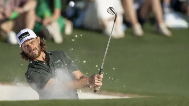 Tommy Fleetwood hitting a ball out of a bunker at Augusta National