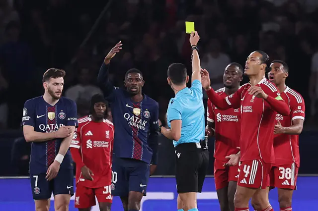 Spanish referee Jose Maria Sanchez shows a yellow card for a penalty then cancelled