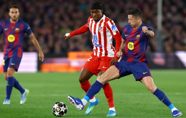 FC Barcelona's Robert Lewandowski in action with Atletico Madrid's Ademola Lookman