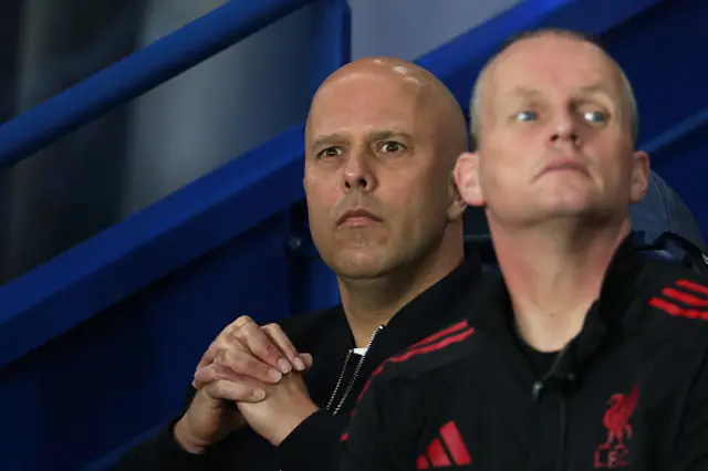 Liverpool's Dutch manager Arne Slot (L) looks on