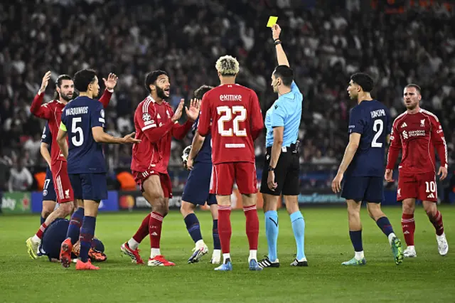 Spanish referee Jose Maria Sanchez (3rdR) shows a yellow card