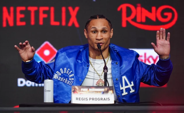 Regis Prograis holds his hands up as his speaks
