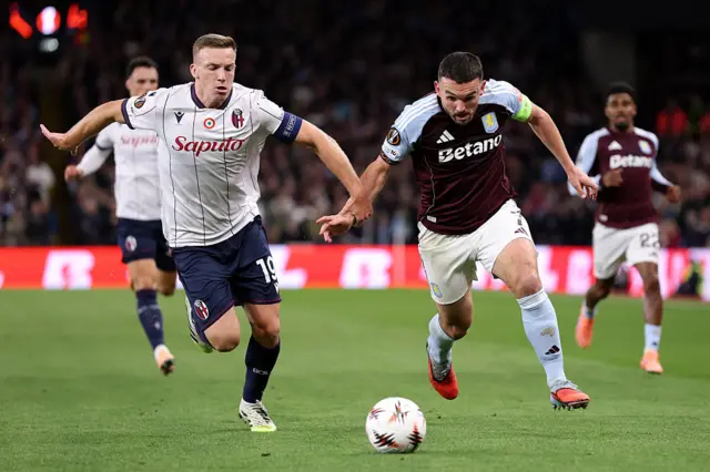John McGinn playing for Villa and Lewis Ferguson playing for Bologna