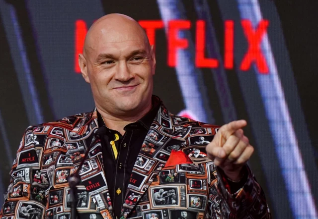 Tyson Fury smiles and points