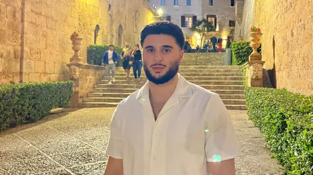 Man in white shirt stand on a concrete floor