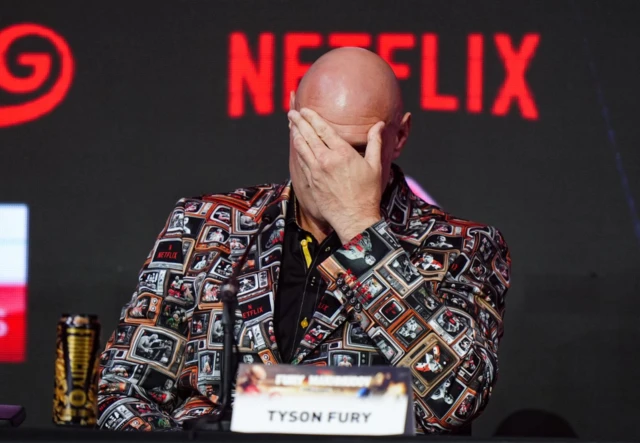Tyson Fury brings his hand to his forehead