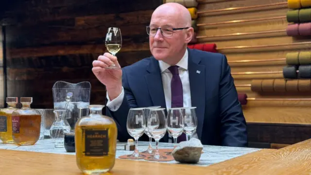SNP leader John Swinney in a Harris distillery sampling a dram