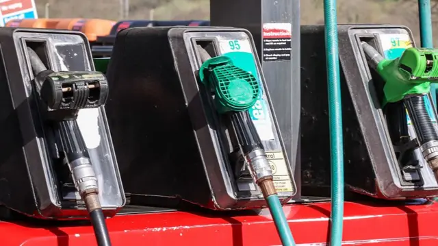 A picture of petrol pumps at a gas station