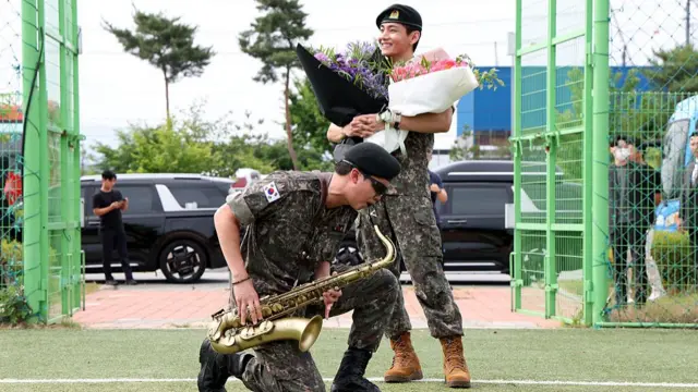 RM (L) and V (R) react after being discharged from a mandatory military service on June 10, 2025