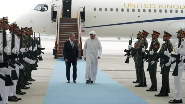Keir Starmer welcomed by Khaldoon Khalifa Al Mubarak, chairman of the Executive Affairs Authority, as he arrives at the airport in Abu Dhabi in the UAE earlier today