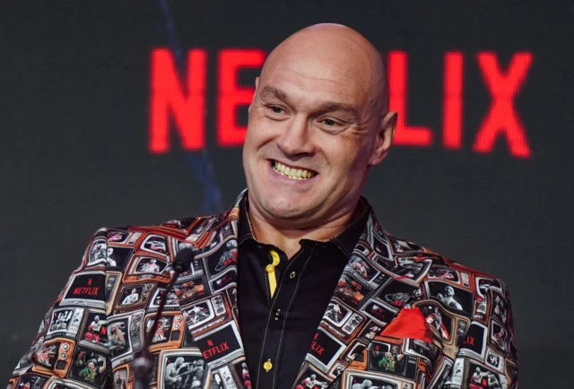 Tyson Fury smiles at a news conference