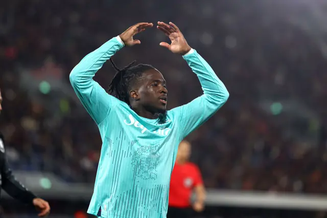 Rowe waves his hands to gee up the fans