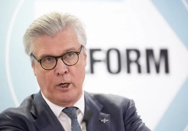 Malcolm Offord with a Reform sign behind him