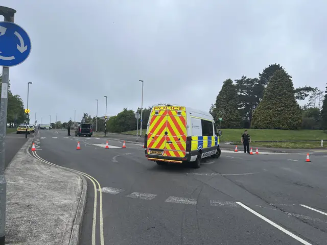 Police van in the road.