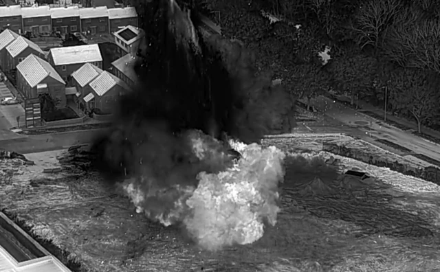 Black and white photo of bomb being destroyed.