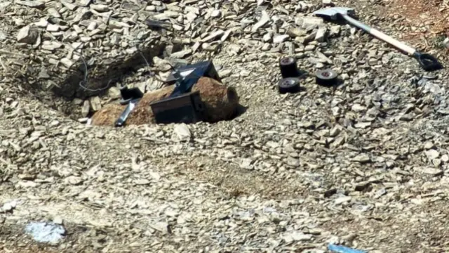 A bomb with a number of metal attachments on a building site.