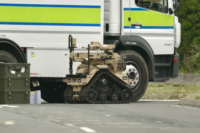 Brown robot in front of a lorry.