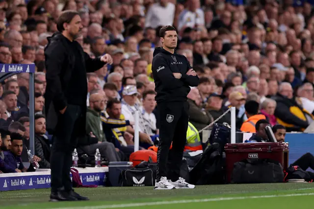 Both managers watch on from the touchline