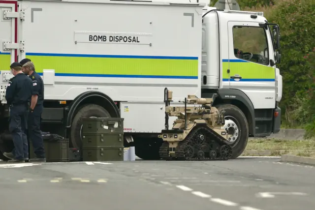 Brown robot in front of a lorry