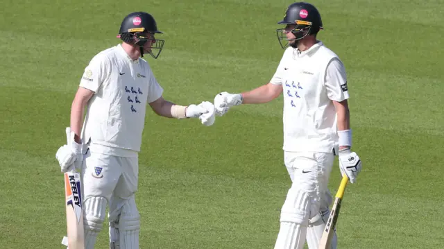 Jack Carson and Ollie Robinson bump fists