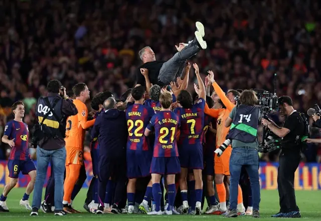 Barcelona's players celebrate with Barcelona's German coach Hans-Dieter Flick