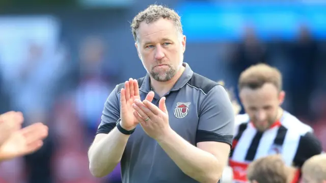 David Artell, manager of Grimsby Town claps to fans during their end of season lap of honour
