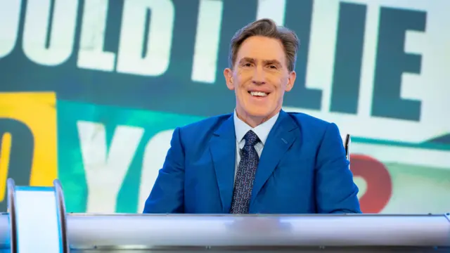 Would I Lie to You host Rob Brydon posing in the programme's main studio for promotional pictures