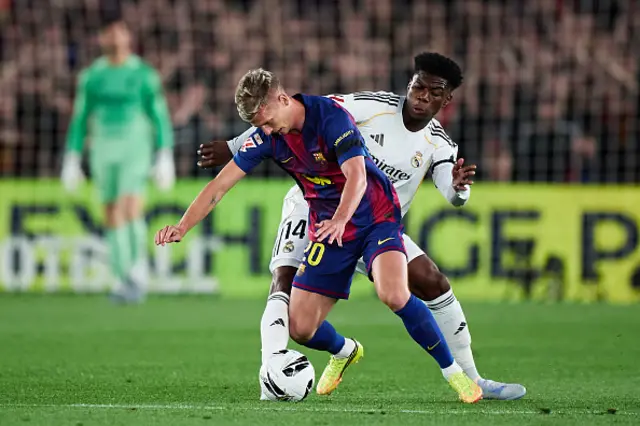 Aurelien Tchouameni of Real Madrid competes for the ball with Dani Olmo