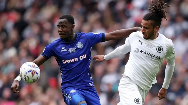 Chris Bush of Boreham Wood battles for possession with Mani Dieseruvwe of Rochdale