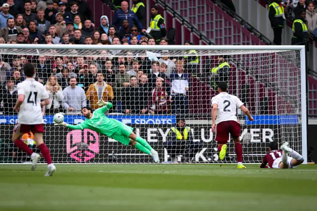 David Raya of Arsenal saves from Taty Castellanos of West Ham United