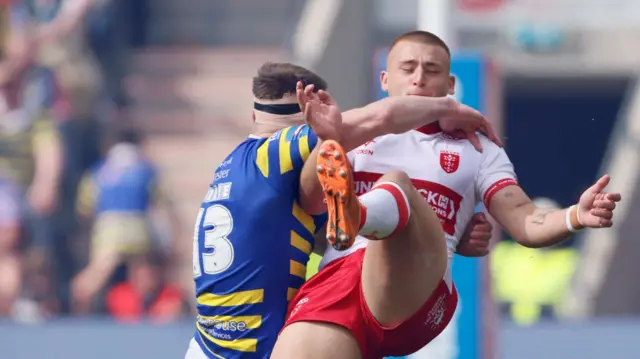 Warrington's Ben Currie tackles Hull KR's Mikey Lewis