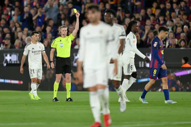 Referee Alejandro Hernandez Hernandez shows a yellow card to Eduardo Camavinga