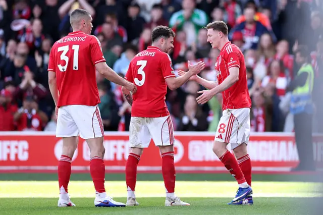 Elliot Anderson of Nottingham Forest celebrates scoring his team's first goal with teammates Neco Williams and Nikola Milenkovic