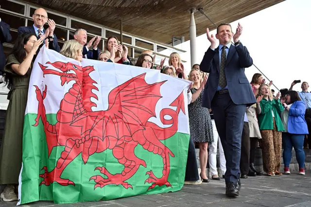 Plaid Cymru party holding Welsh flag