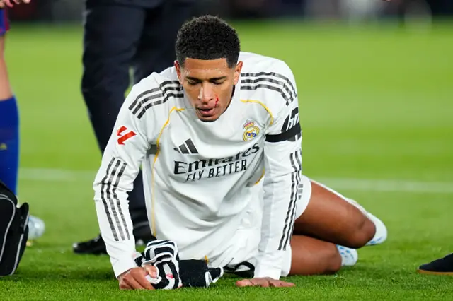 Jude Bellingham central midfield of Real Madrid and England lies injured on the pitch