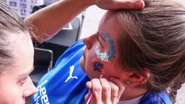 A Chesterfield fan has her face painted outside the SMH Group Stadium