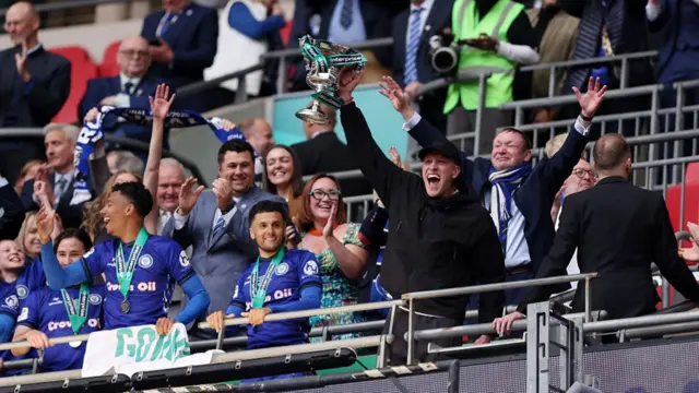 Jimmy McNulty, Manager of Rochdale, celebrates with the play off trophy
