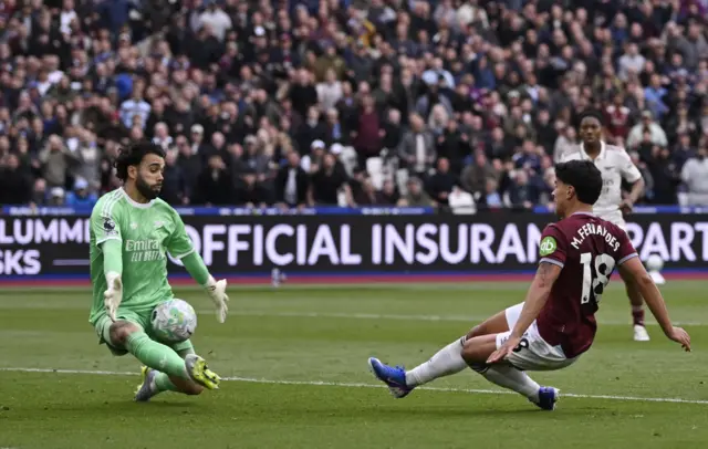 Arsenal's David Raya saves a shot from West Ham United's Mateus Fernandes