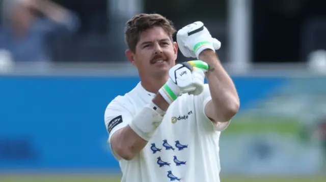 Sussex opener Daniel Hughes celebrates his century